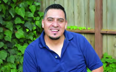 Antonio, pictured with his housing success story in the 2022 annual report.