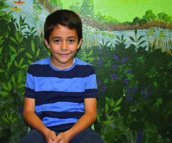 Fabian, pictured with his learning story in the 2022 annual report.