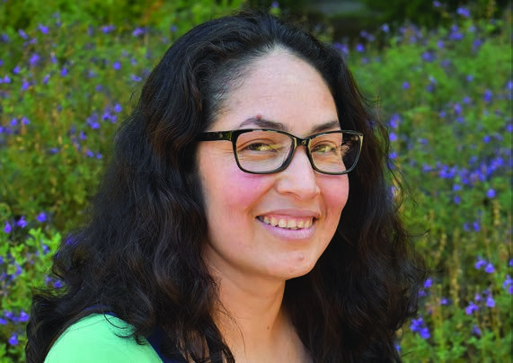 Ofelia, pictured with her education story in the 2023 annual report.